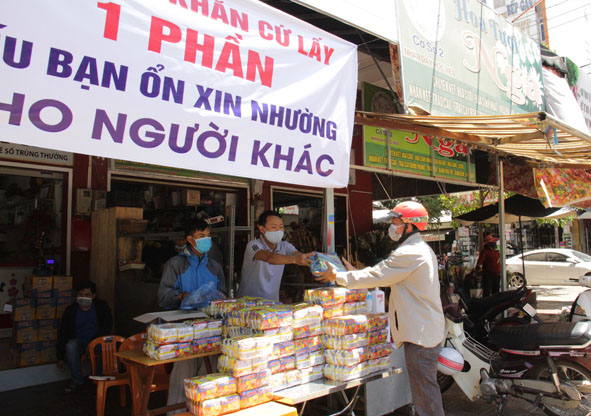 Đại lý vé số Kim Lan tặng mì gói cho những người cần.